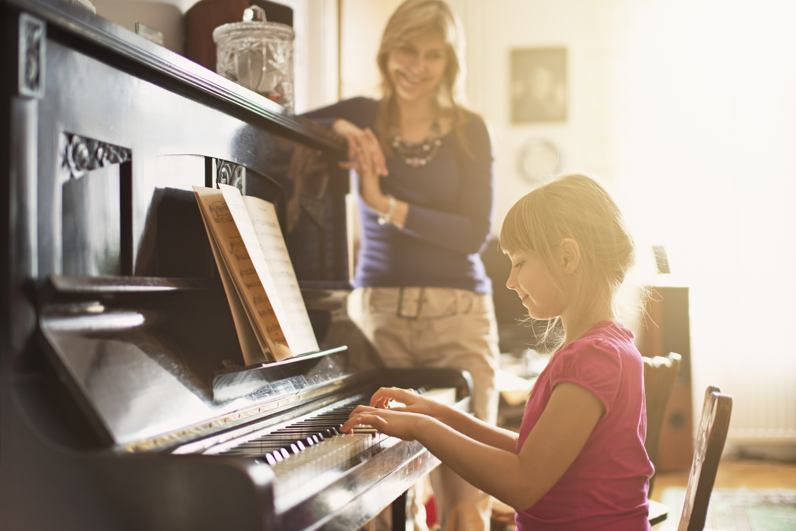 Background image of a young girl playing the piano